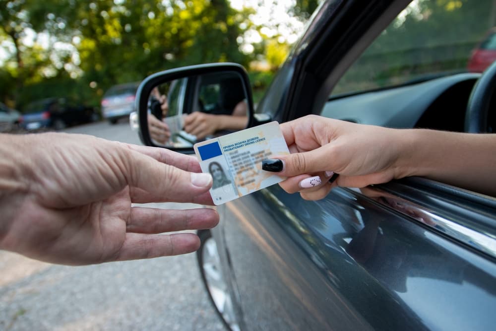 A female driver showing license to policeman after DWI stop in North Carolina