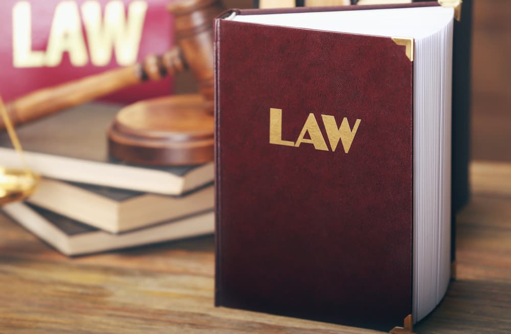 A law book resting on a wooden background.